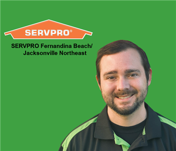 Head and shoulders photo of Christon Overly superimposed over green background with SERVPRO logo