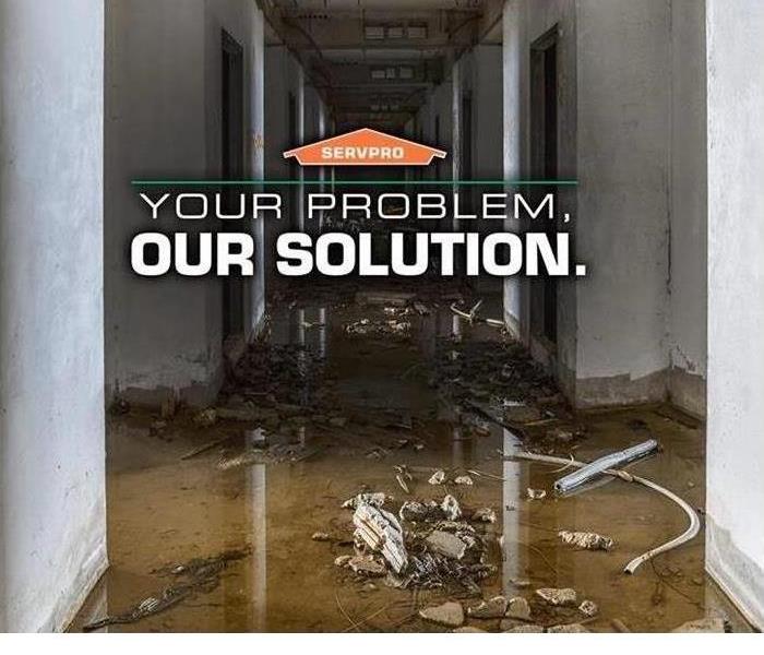 water damage at a property with SERVPRO logo and graphic that says "Your Problem, Our Solution"
