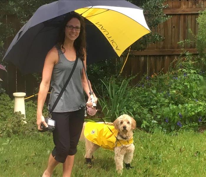 Marketing director, Sarah Branch Howard, along with her dog Sadie, both dressed in rain gear