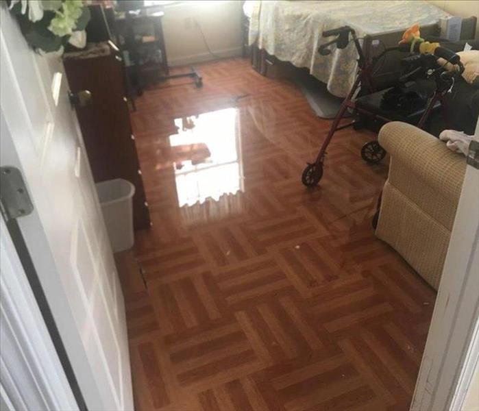 Flooded floor of the living quarters of a resident in an assisted living facility.