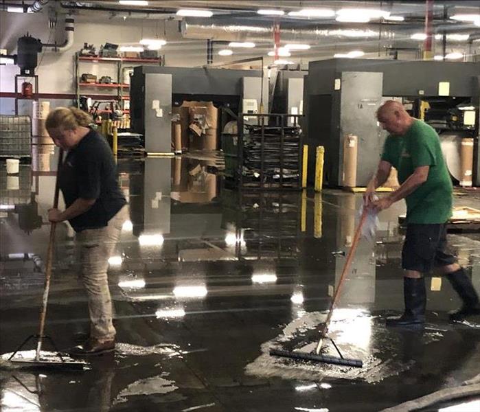 Two SERVPRO of Fernandina Beach/Jacksonville Northeast technicians extracting water at a Jacksonville warehouse.